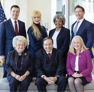 Group portrait of Goodyear City Council members seated and standing in two rows.