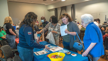 Three women are gathered around a table with a bowl of fruit on it. They are engaged in conversation and appear to be enjoying their time together.

AI generated content