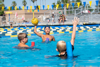 A group of children playing in a pool, one of them holding a yellow ball.

AI generated content