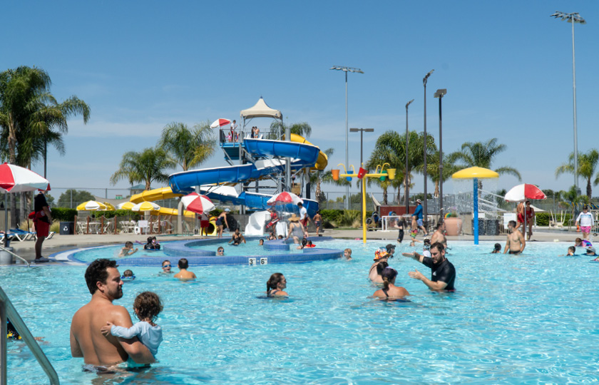 A large group of people are swimming in a pool, with some of them on a water slide.

AI generated content