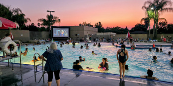 A large crowd of people are in a public pool, enjoying a sunny day.

AI generated content