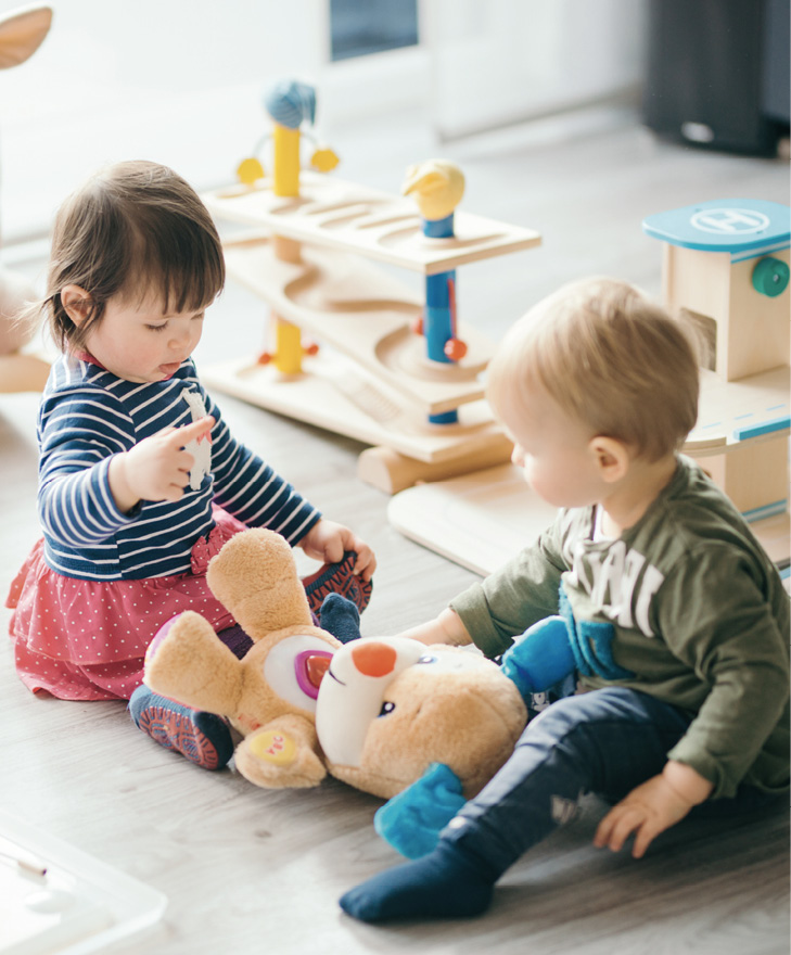 Cute little girl and boy playing with toys by the home.
