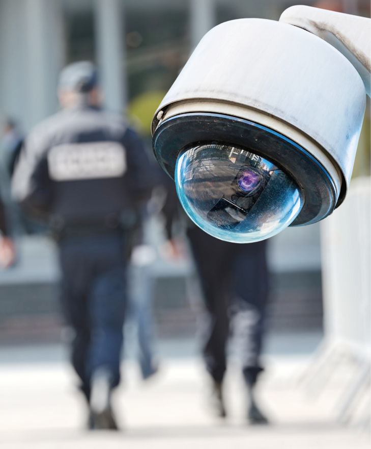 Security CCTV camera or surveillance system with military on blurry background.