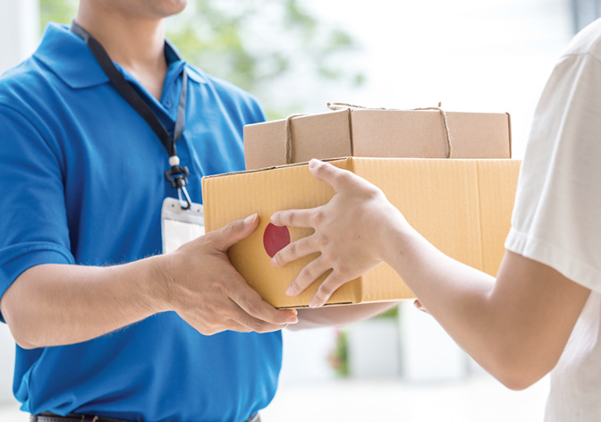 Woman hand accepting a delivery of boxes from deliveryman.
