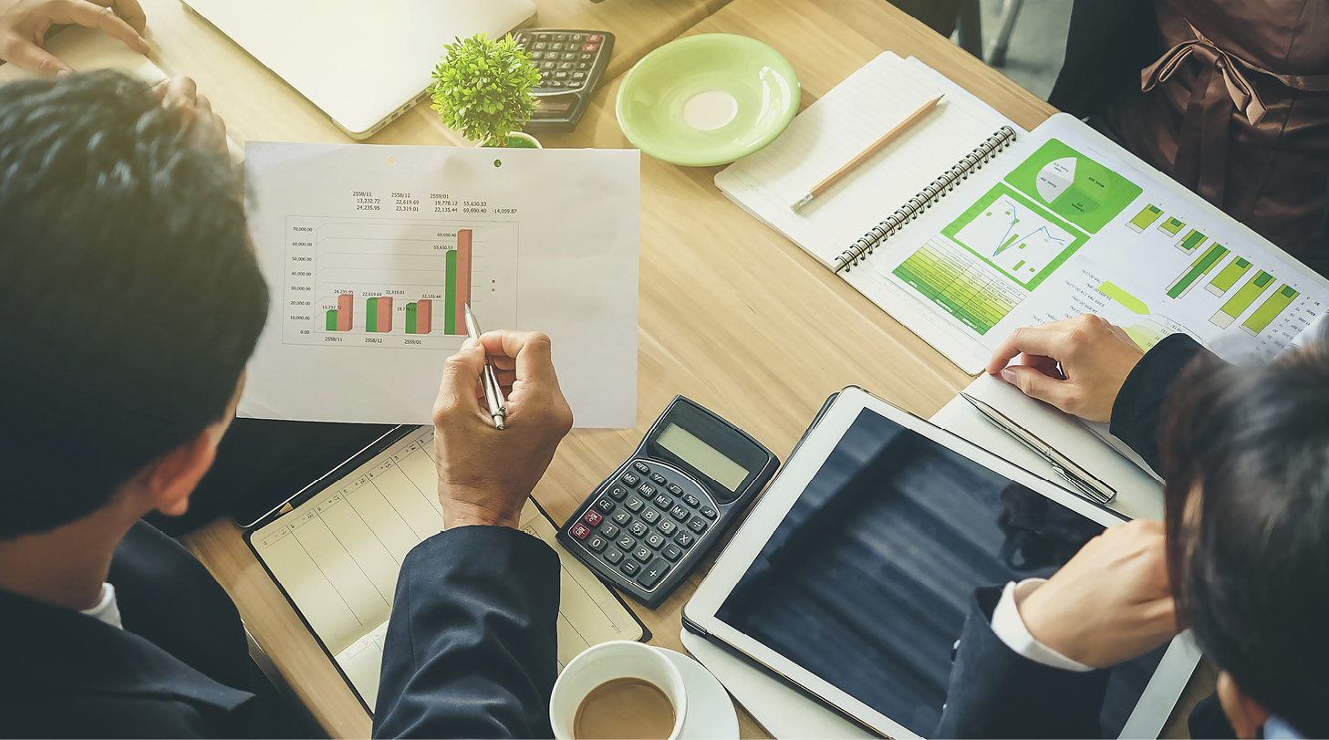 Team of business consulting, analysis of business plans. For profit and stability of business sustainability. Focus on hand Business man holding pen.