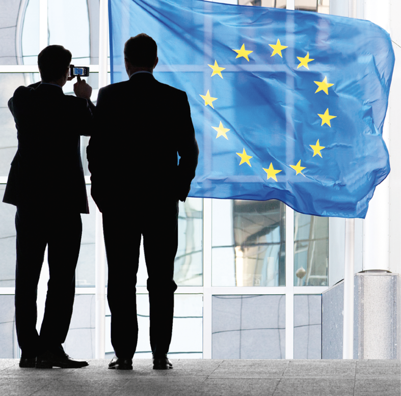People Walking to Work. Flags with European Parliament in Brussels. Belgium.