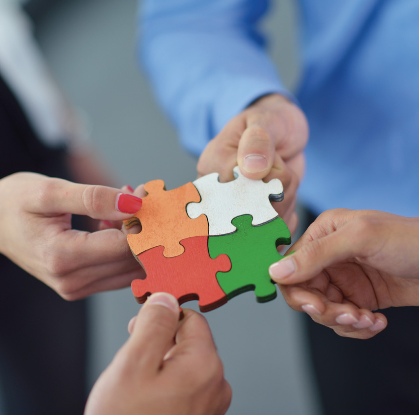 Group of business people assembling jigsaw puzzle and represent team support and help concept.