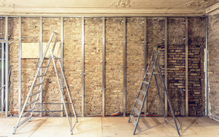 Working process of installing metal frames for plasterboard for making gypsum walls and ladders in apartment is under construction, remodeling, renovation, extension, restoration and reconstruction.