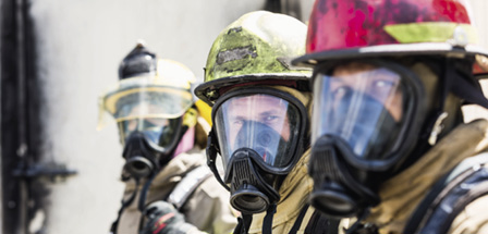 Three Firefighters Wearing Oxygen Masks.