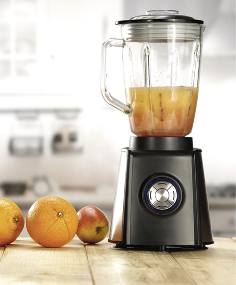 Yellow wooden kitchen table and fresh juice and fruits on desk top.