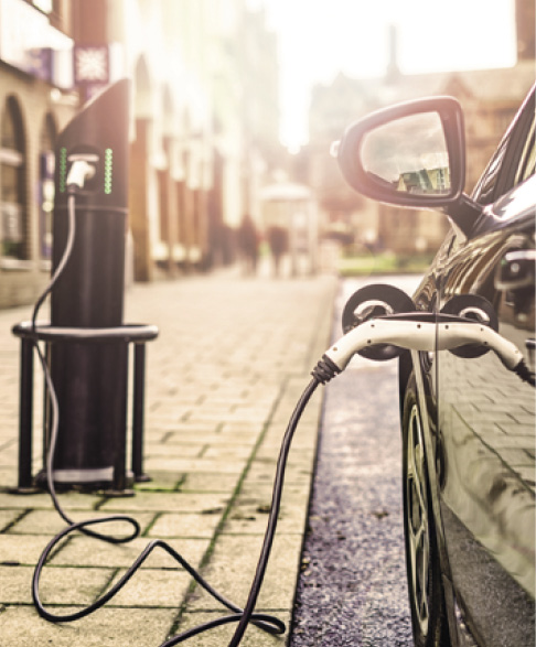 Electric Vehicle is changing in street.