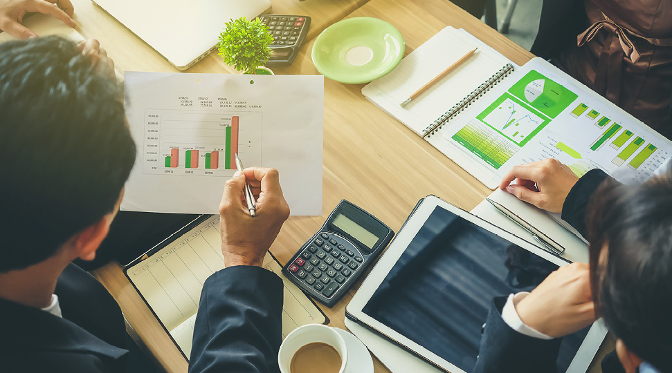 Team of business consulting, analysis of business plans. For profit and stability of business sustainability. Focus on hand Business man holding pen.