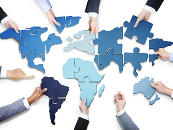 Business People with Jigsaw Puzzle Forming World Map.