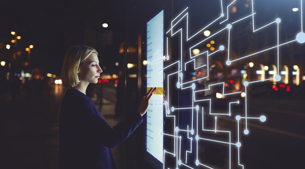 Young woman touching sensitive screen while selecting surface option. Female standing at big display with advanced innovative device with infographics design elements.Person with futuristic technology.